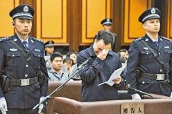 The former Communist Party Chief of Guangzhou, Wan Qinliang cries during his trial in this undated file photo.