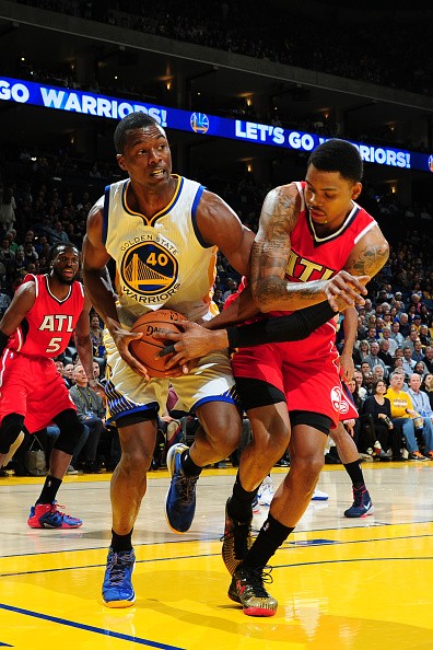 Harrison Barnes of the Golden State Warriors fights for the ball against Kent Bazemore of the Atlanta Hawks at Oracle Arena in Oakland, California.